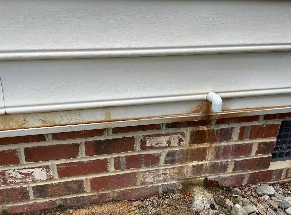 rusty pipe and siding with brick 