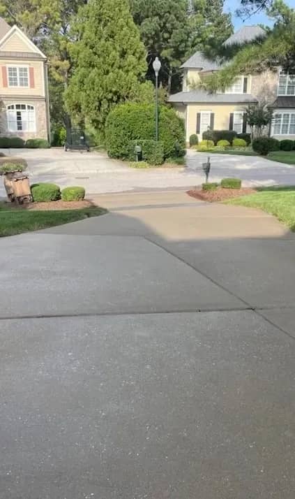 A clean, wet Wake Forest North Carolina Driveway after stains removed by powerwashing